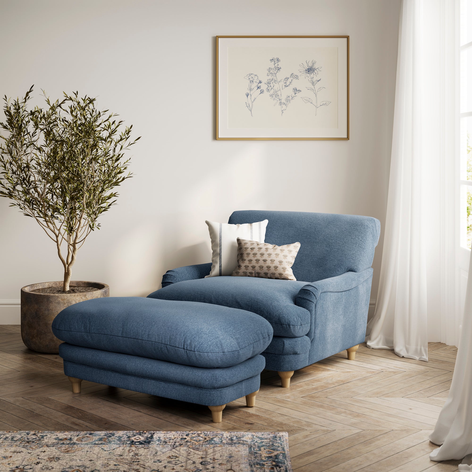 Large blue chenille armchair with wooden legs and matching footstool