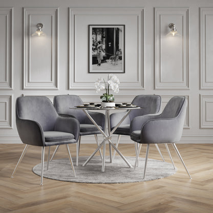 Dining room with grey dining chairs around a silver round table,