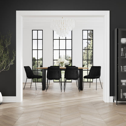 Modern dining room with black chairs, wooden table, and large windows.