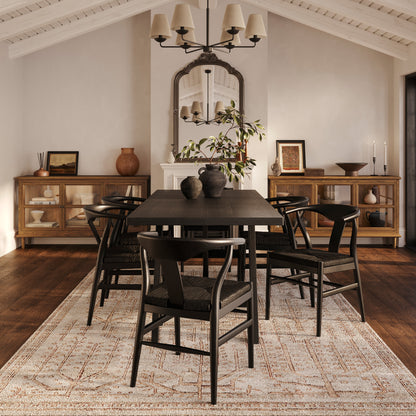 Black dining chair with grey cushion and brown wooden table 