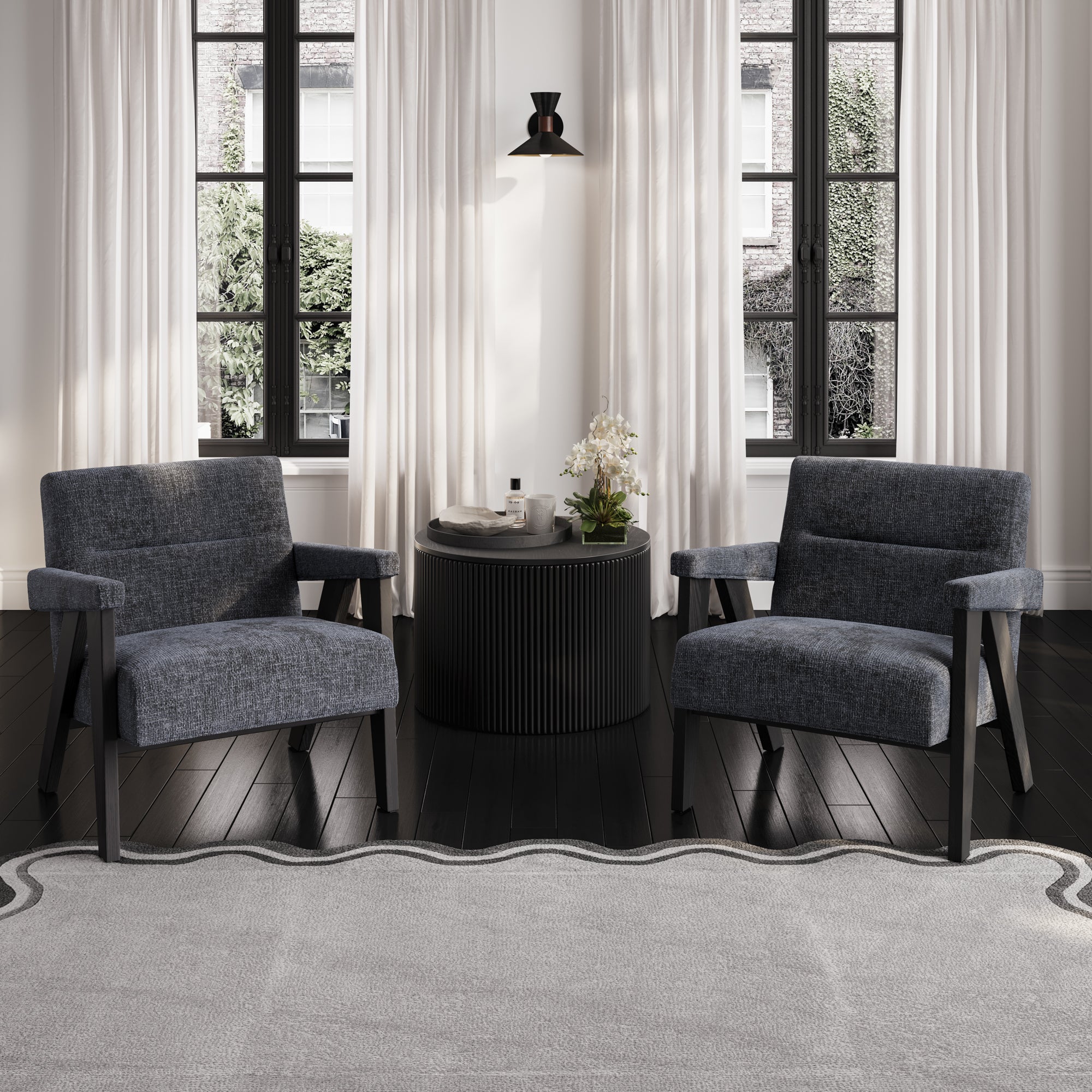 Grey velvet armchair with black wooden legs with small black round table
