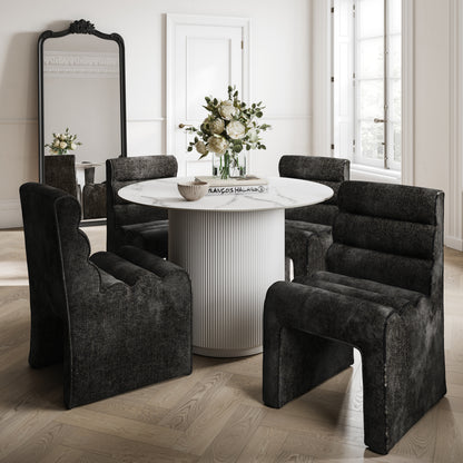 Round marble effect table with a white base and black velvet chairs