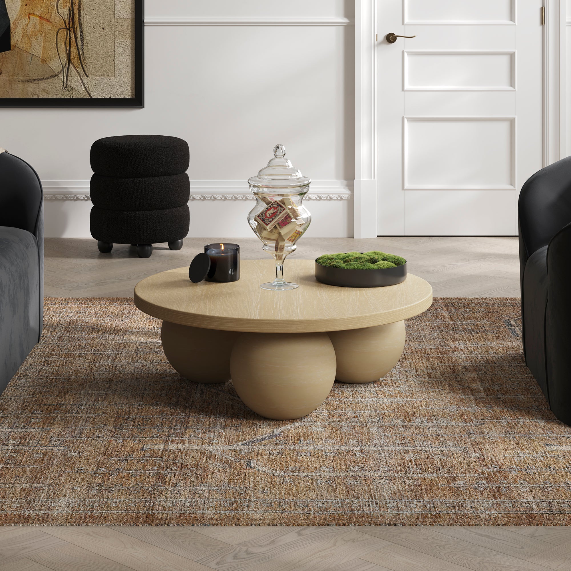 Black round coffee table with three spherical bases 