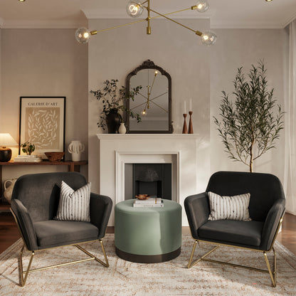 Large round sage green stool with matte black base with black velvet armchairs 