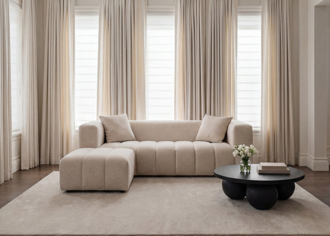 Soft Beige Chenille Pouffe stool with matching beige sofa in a neutral coloured living room