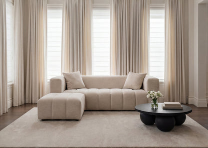 Soft Beige Chenille Pouffe stool with matching beige sofa in a neutral coloured living room