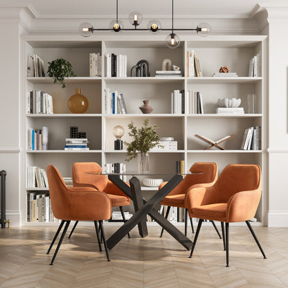 Dining area with rust brownchairs and a black dining table 